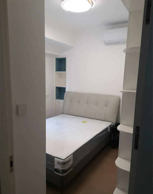 The bedroom has a wooden floor